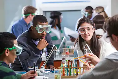 A group of four teenagers around science beakers