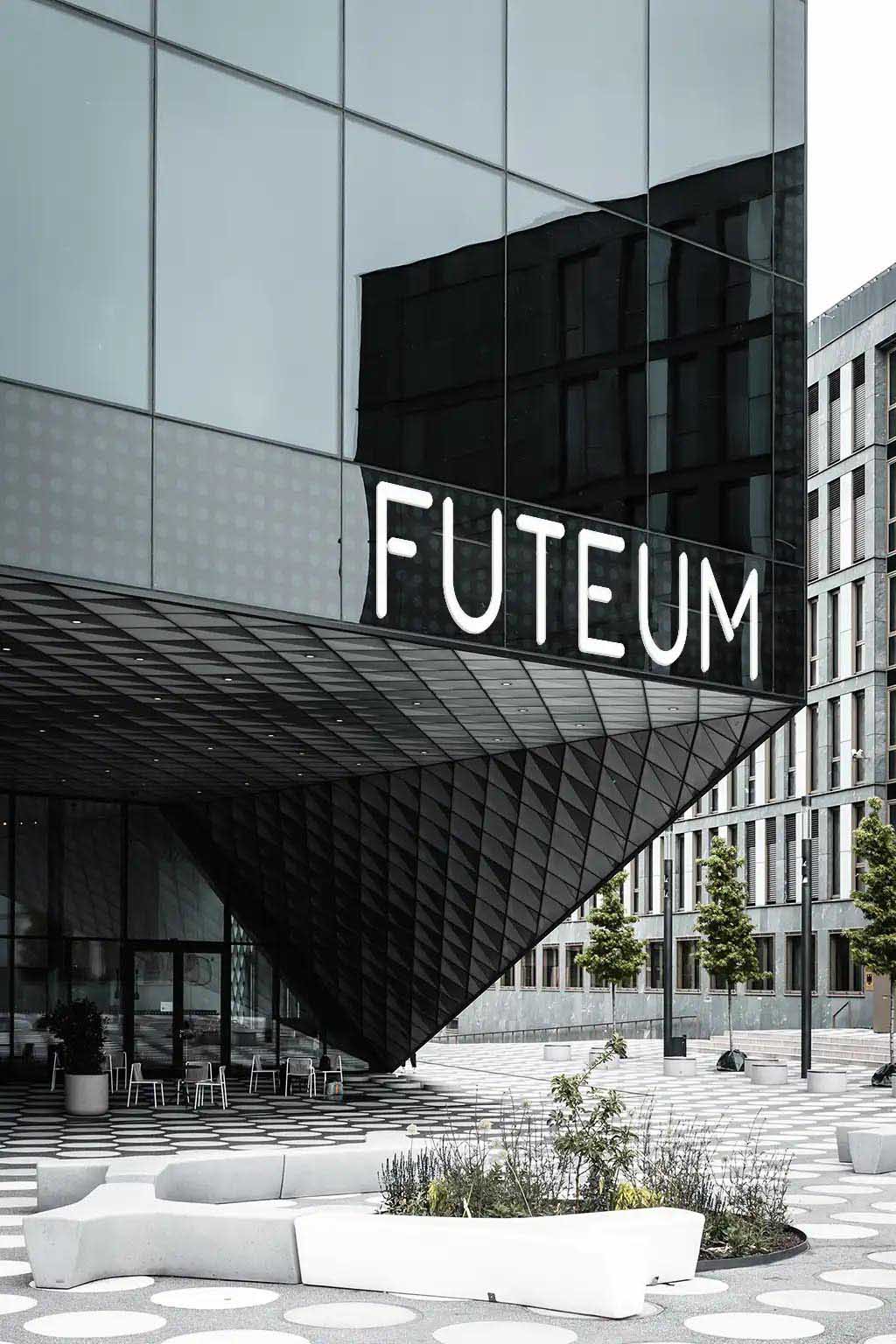 A large modren looking building with a glass front and the Futeum logo on a big sign