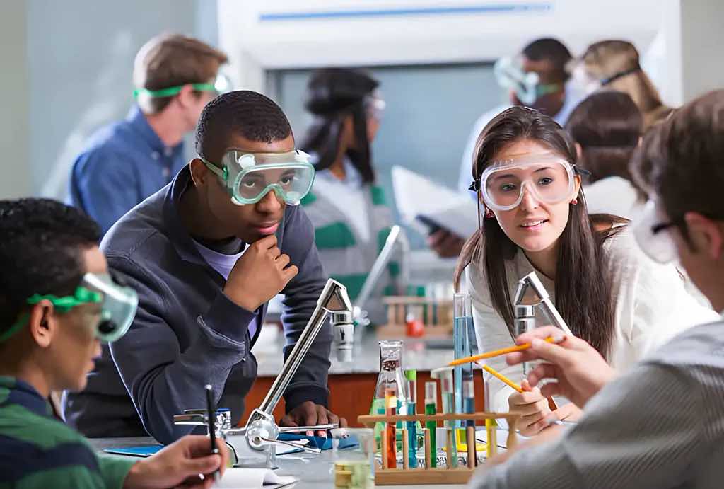 A group of teenagers around science beakers